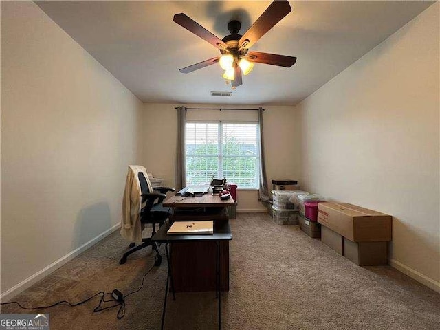 carpeted office featuring visible vents, ceiling fan, and baseboards