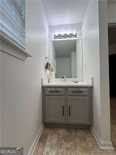 bathroom with vanity and baseboards