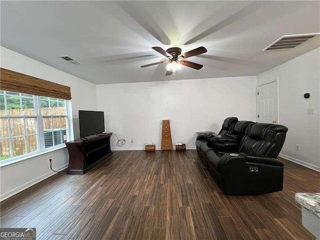 living room featuring wood finished floors, ceiling fan, baseboards, and visible vents
