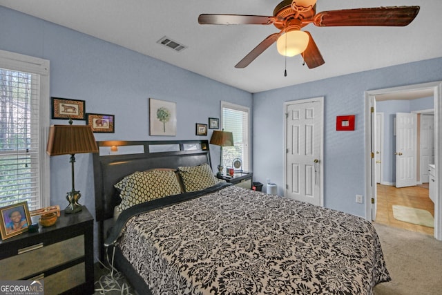 bedroom featuring visible vents, a ceiling fan, and carpet floors