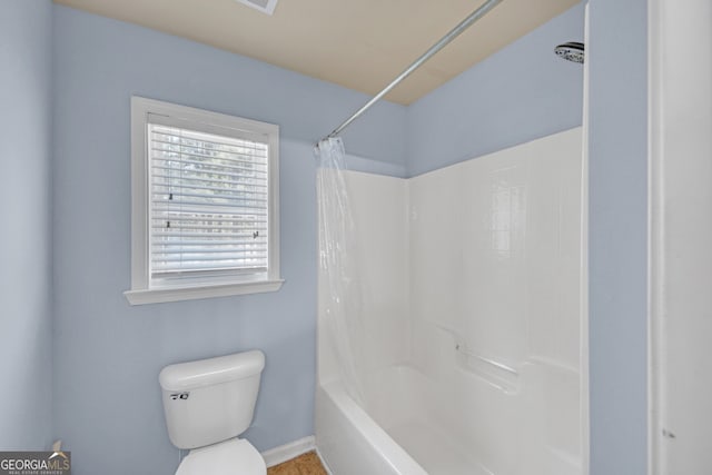 bathroom featuring shower / tub combo and toilet