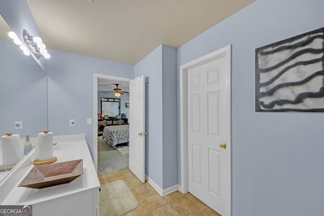 ensuite bathroom featuring ensuite bathroom, ceiling fan, and vanity
