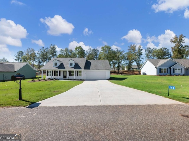 view of front facade featuring a front yard, an attached garage, and driveway