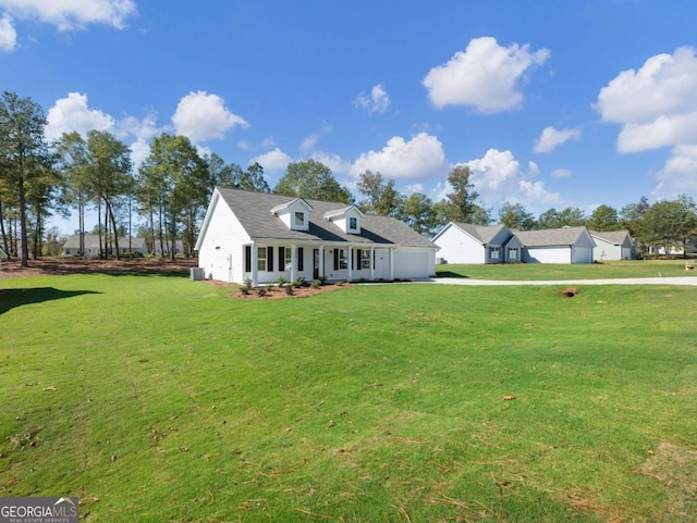 new england style home with a front lawn, an attached garage, driveway, and cooling unit