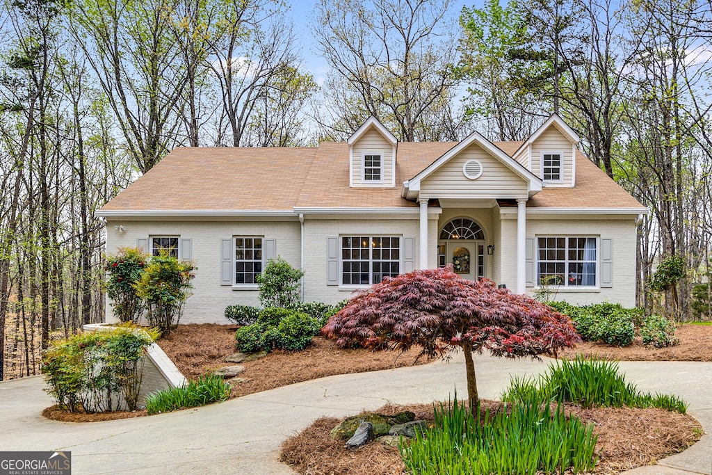 new england style home with brick siding