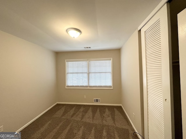 3539 Meadowridge Dr SW, Atlanta, GA 30331 - unfurnished bedroom with dark colored carpet, visible vents, a closet, and baseboards