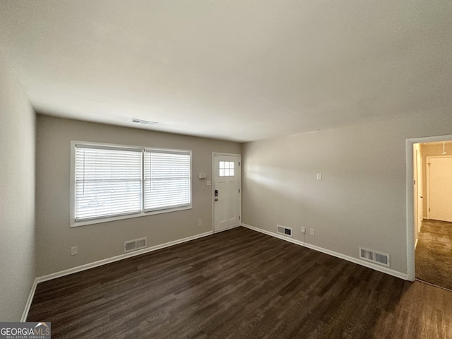 3539 Meadowridge Dr SW, Atlanta, GA 30331 - unfurnished living room featuring dark wood-type flooring and visible vents