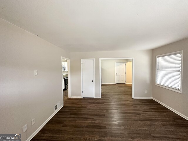 3539 Meadowridge Dr SW, Atlanta, GA 30331 - empty room featuring baseboards, dark wood finished floors, and visible vents