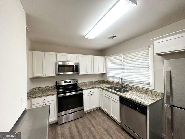 3539 Meadowridge Dr SW, Atlanta, GA 30331 - kitchen with stainless steel appliances, white cabinetry, a sink, and dark wood finished floors