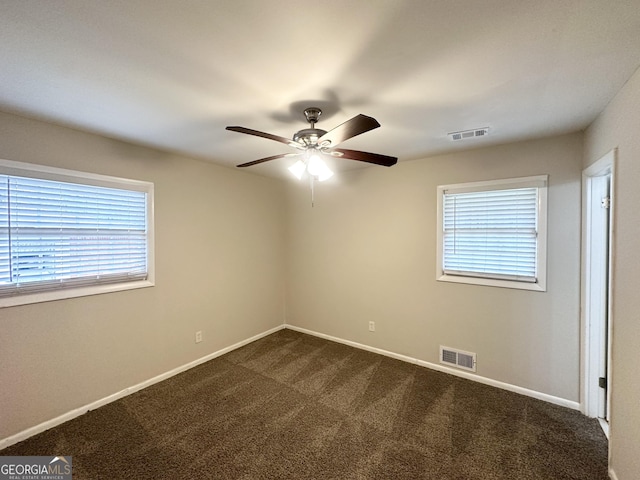 3539 Meadowridge Dr SW, Atlanta, GA 30331 - spare room featuring a wealth of natural light, dark colored carpet, visible vents, and ceiling fan