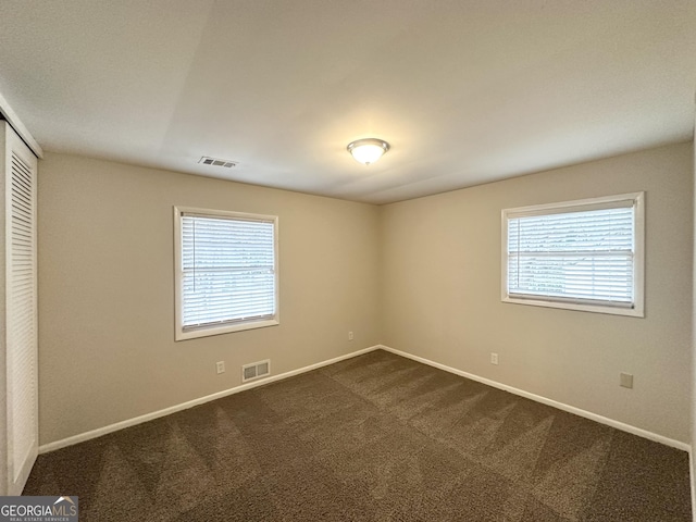 3539 Meadowridge Dr SW, Atlanta, GA 30331 - unfurnished bedroom featuring baseboards, visible vents, a closet, and dark carpet