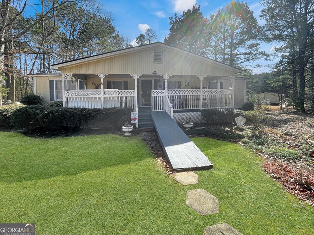 451 Weldon Lake Rd, Milner, GA 30257 - view of front facade with a porch and a front lawn