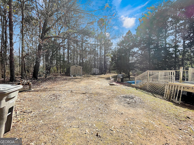 451 Weldon Lake Rd, Milner, GA 30257 - view of yard featuring a storage shed, a wooden deck, and an outbuilding