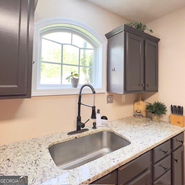 33 Mountain View Dr, Rockmart, GA 30153 - kitchen featuring gray cabinetry and light stone countertops