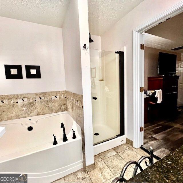33 Mountain View Dr, Rockmart, GA 30153 - bathroom featuring a shower stall, a bath, and a textured ceiling