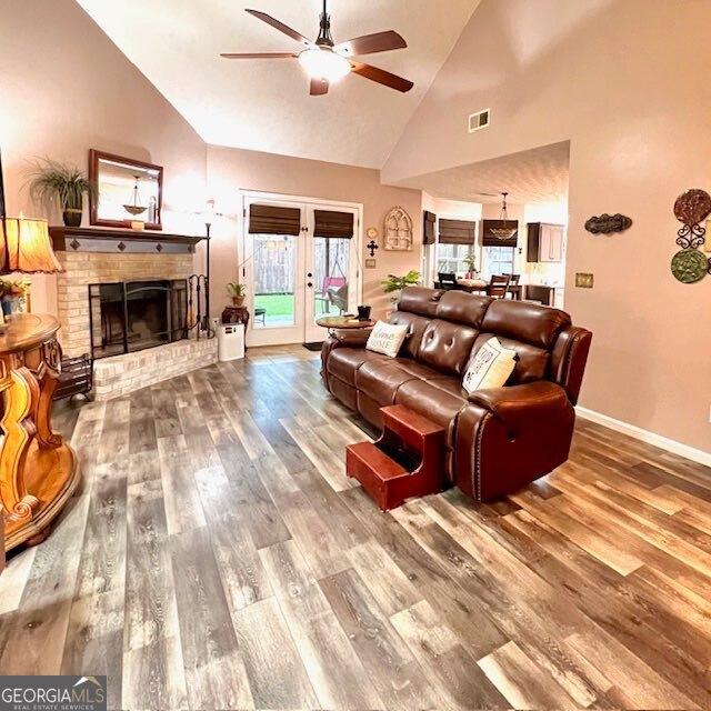 33 Mountain View Dr, Rockmart, GA 30153 - living area featuring high vaulted ceiling, ceiling fan, wood finished floors, and a brick fireplace