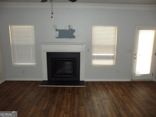 unfurnished living room with wood finished floors, baseboards, crown molding, and ceiling fan