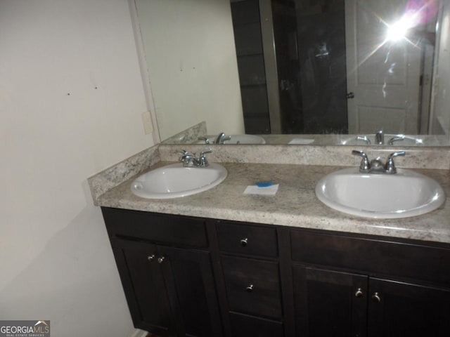 bathroom featuring double vanity and a sink