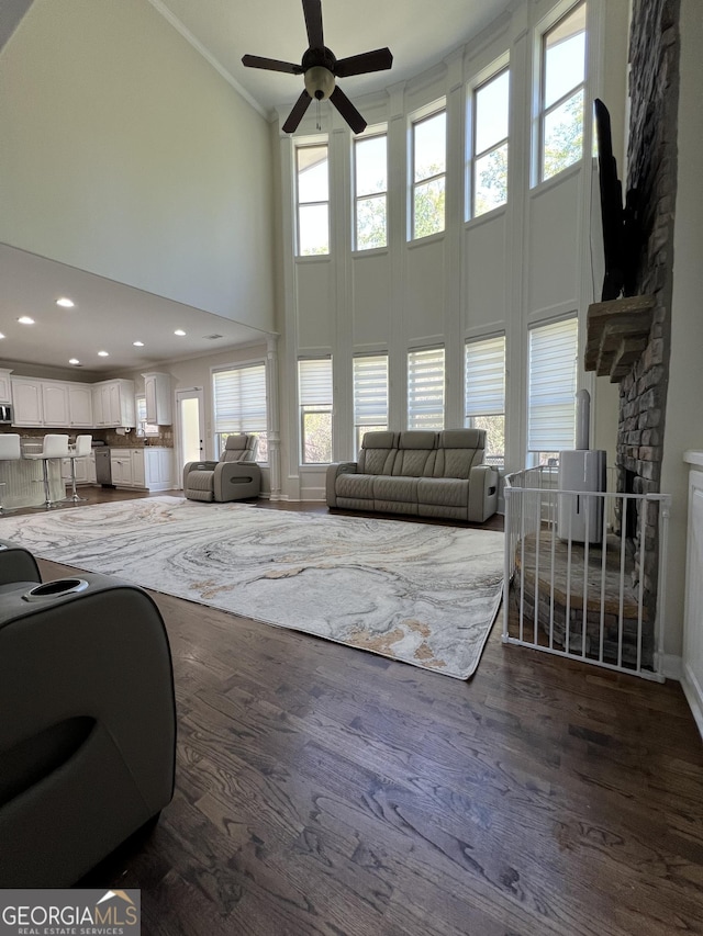 living room featuring a wealth of natural light, ornamental molding, high vaulted ceiling, and ceiling fan