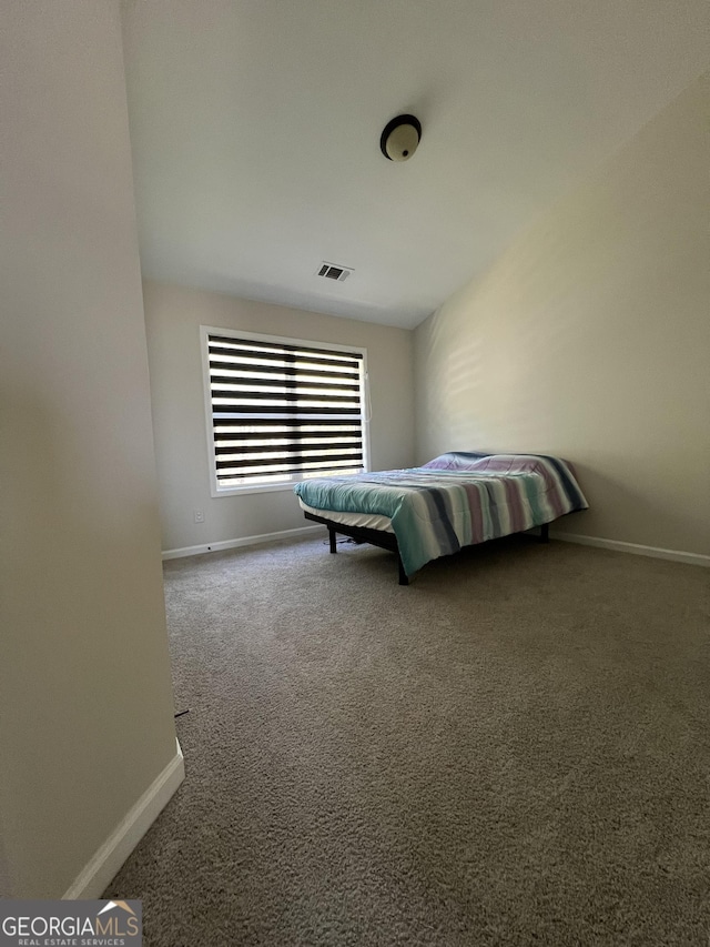 carpeted bedroom featuring baseboards and visible vents