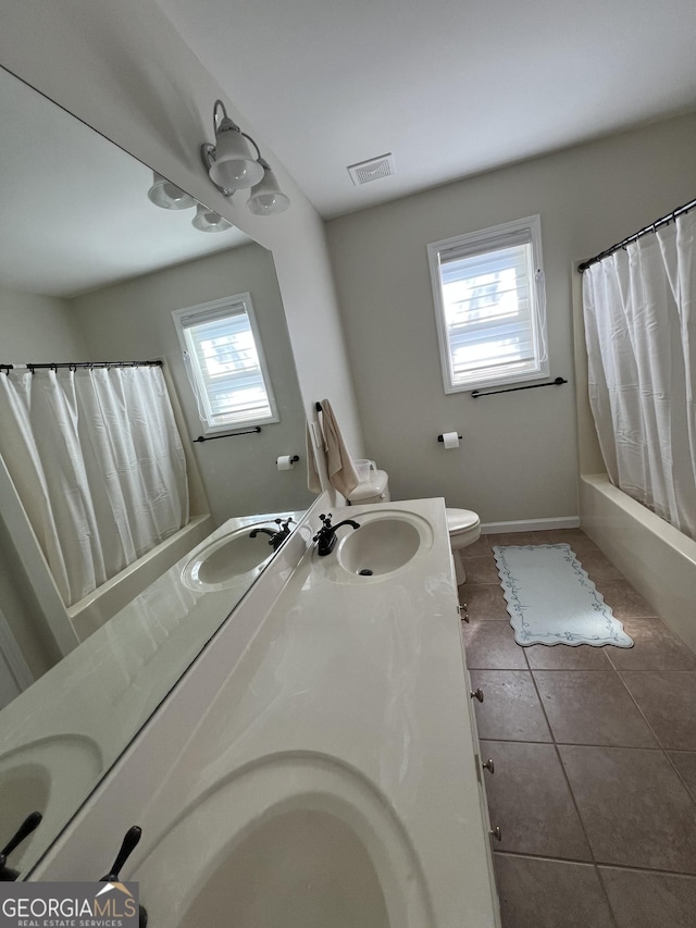 full bathroom featuring double vanity, tile patterned floors, and a sink