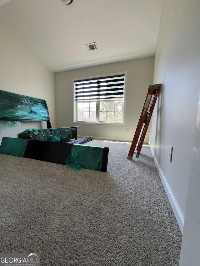 bedroom with carpet floors, visible vents, and baseboards