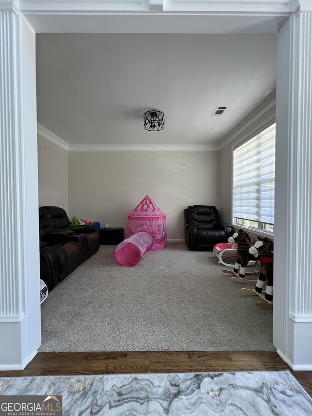 playroom featuring baseboards, crown molding, carpet flooring, and visible vents