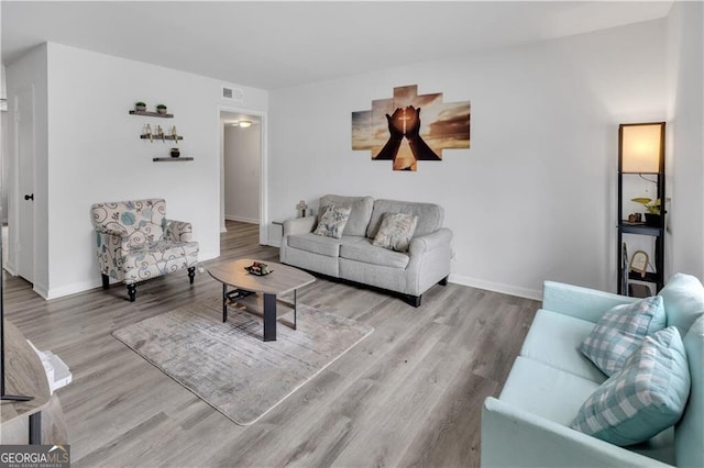1204 Lakeview Dr NW, Conyers, GA 30012 - living area featuring visible vents, baseboards, and wood finished floors