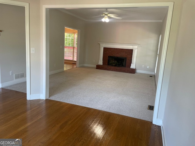 8100 Greens Mill Way, Loganville, GA 30052 - unfurnished living room with a ceiling fan, ornamental molding, wood finished floors, baseboards, and a brick fireplace