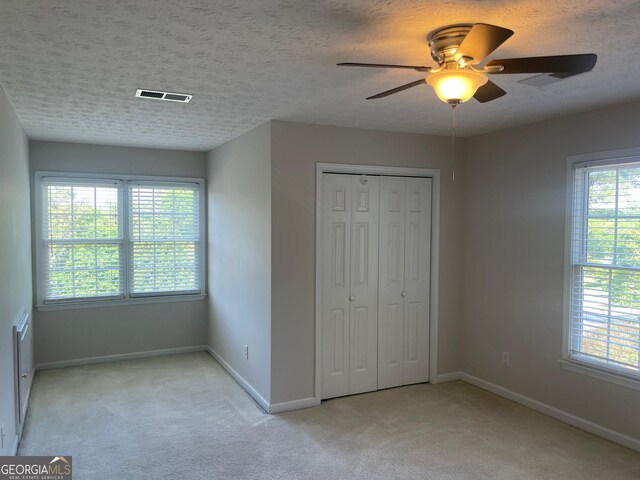 8100 Greens Mill Way, Loganville, GA 30052 - unfurnished bedroom featuring carpet floors, baseboards, a closet, ceiling fan, and a textured ceiling