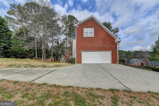 8100 Greens Mill Way, Loganville, GA 30052 - view of home's exterior with driveway, a garage, brick siding, and a lawn