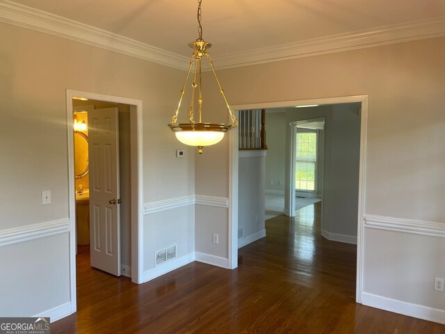8100 Greens Mill Way, Loganville, GA 30052 - unfurnished dining area with wood finished floors, crown molding, and baseboards