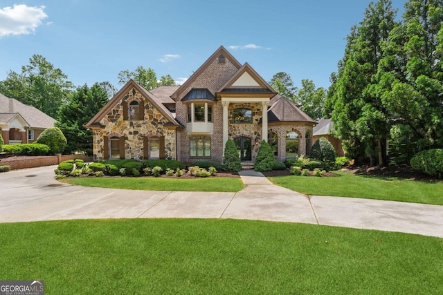 6935 Wakehurst Pl, Cumming, GA 30040 - view of front of property featuring a front yard and stone siding