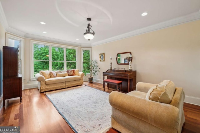 6935 Wakehurst Pl, Cumming, GA 30040 - living area with ornamental molding, wood finished floors, recessed lighting, and baseboards