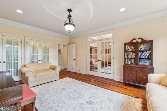 6935 Wakehurst Pl, Cumming, GA 30040 - living room featuring french doors, wood finished floors, crown molding, baseboards, and recessed lighting