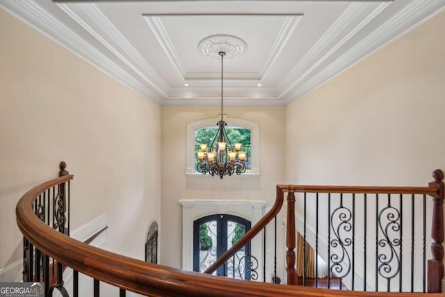 6935 Wakehurst Pl, Cumming, GA 30040 - foyer featuring a chandelier, plenty of natural light, ornamental molding, a raised ceiling, and french doors