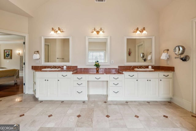 6935 Wakehurst Pl, Cumming, GA 30040 - full bath with double vanity, tile patterned flooring, and lofted ceiling
