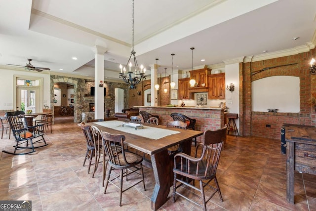 6935 Wakehurst Pl, Cumming, GA 30040 - dining area with ornate columns, crown molding, ceiling fan, a raised ceiling, and a chandelier