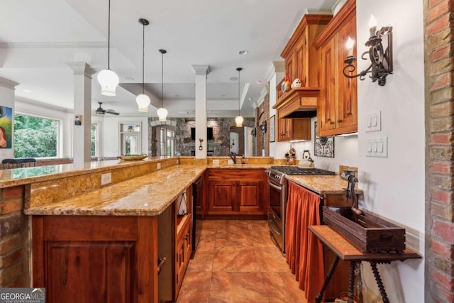 6935 Wakehurst Pl, Cumming, GA 30040 - kitchen with stainless steel gas stove, light stone counters, brown cabinetry, and ornamental molding