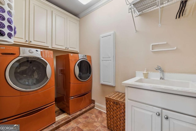 6935 Wakehurst Pl, Cumming, GA 30040 - laundry room with washer and clothes dryer, cabinet space, crown molding, and baseboards