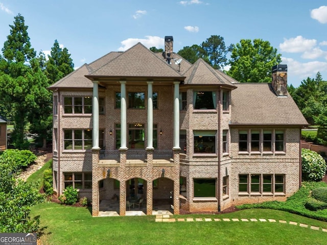 6935 Wakehurst Pl, Cumming, GA 30040 - rear view of property with a chimney, a yard, a patio, and a balcony