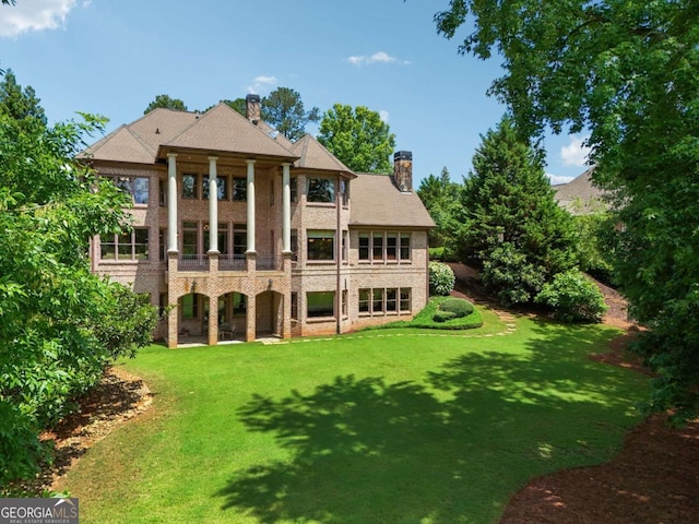 6935 Wakehurst Pl, Cumming, GA 30040 - rear view of property featuring a chimney and a lawn