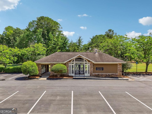 6935 Wakehurst Pl, Cumming, GA 30040 - view of building exterior with uncovered parking
