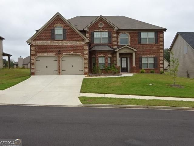 view of front of property with concrete driveway, brick siding, a front yard, and a garage