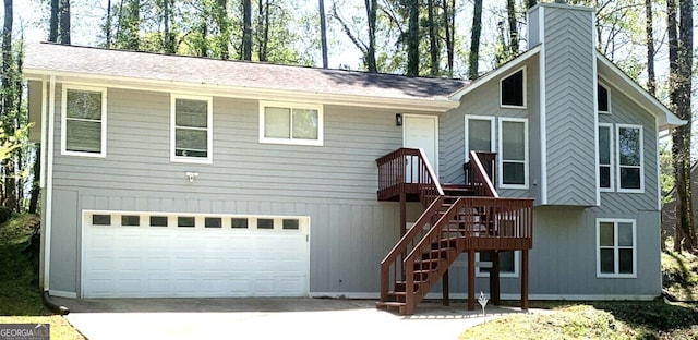 3261 Harbor Woods Rd, Decatur, GA 30034 - back of house featuring a garage, stairway, driveway, and a chimney