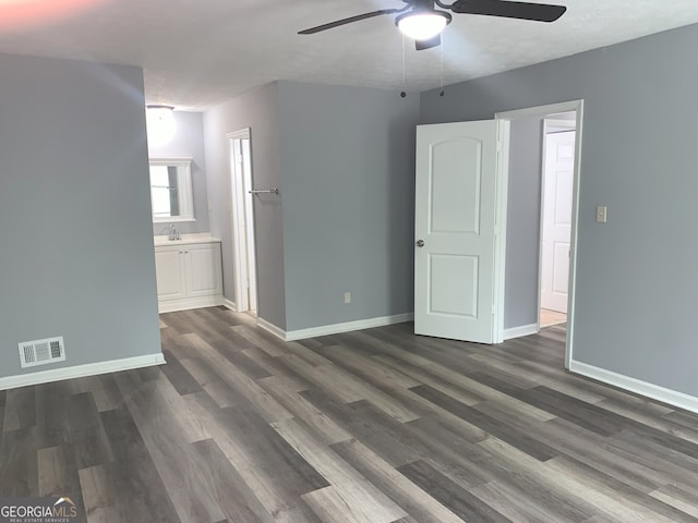 3261 Harbor Woods Rd, Decatur, GA 30034 - unfurnished bedroom with baseboards, connected bathroom, visible vents, dark wood finished floors, and a sink