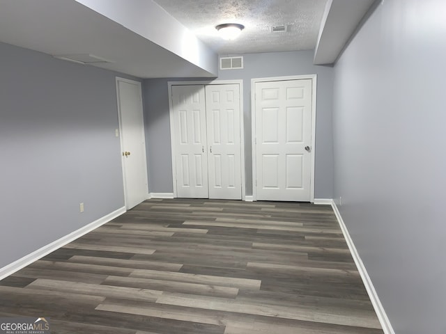 3261 Harbor Woods Rd, Decatur, GA 30034 - unfurnished bedroom featuring a textured ceiling, wood finished floors, baseboards, and visible vents