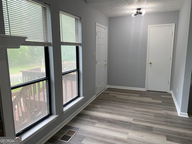 3261 Harbor Woods Rd, Decatur, GA 30034 - empty room with visible vents, a textured ceiling, baseboards, and wood finished floors