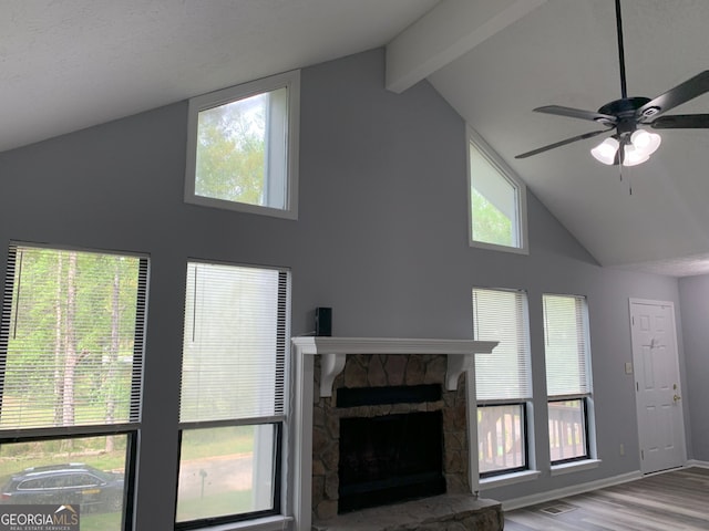 3261 Harbor Woods Rd, Decatur, GA 30034 - unfurnished living room featuring baseboards, a stone fireplace, ceiling fan, beam ceiling, and wood finished floors