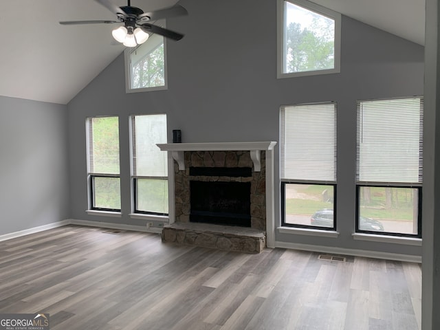 3261 Harbor Woods Rd, Decatur, GA 30034 - unfurnished living room with baseboards, a stone fireplace, visible vents, ceiling fan, and wood finished floors